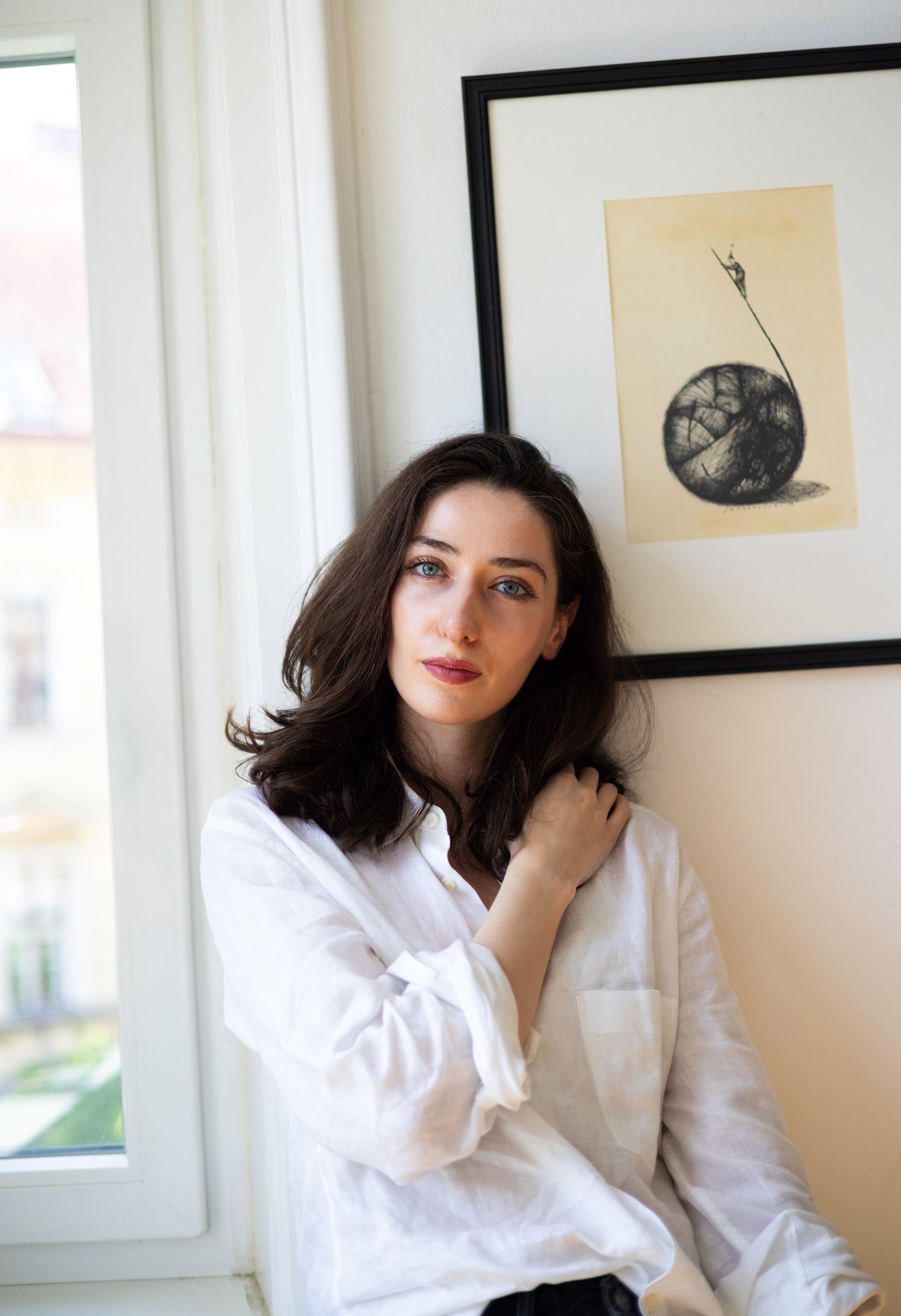 Irma Gigani by a window, in a white shirt