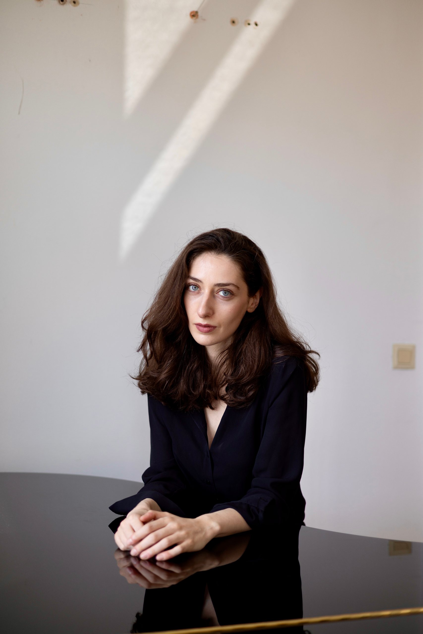 Irma Gigani leaning on a grand piano