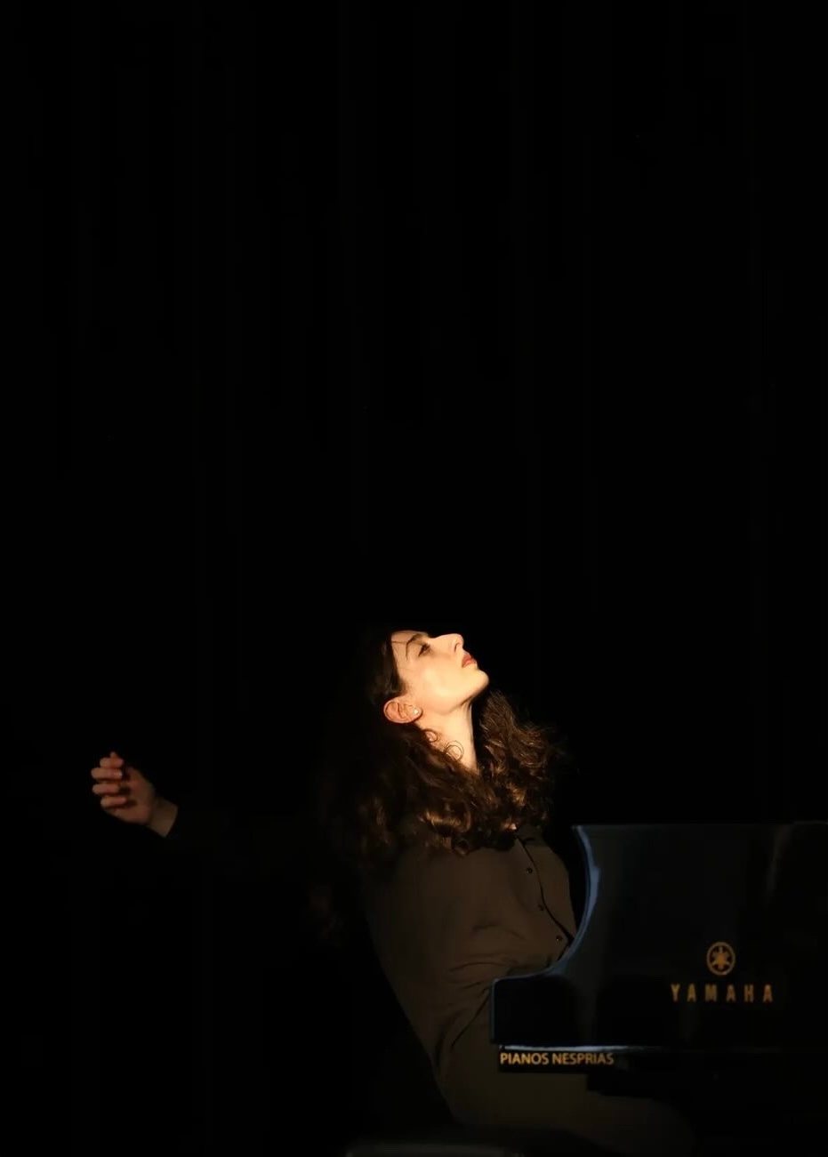 Irma Gigani on stage in a spotlight